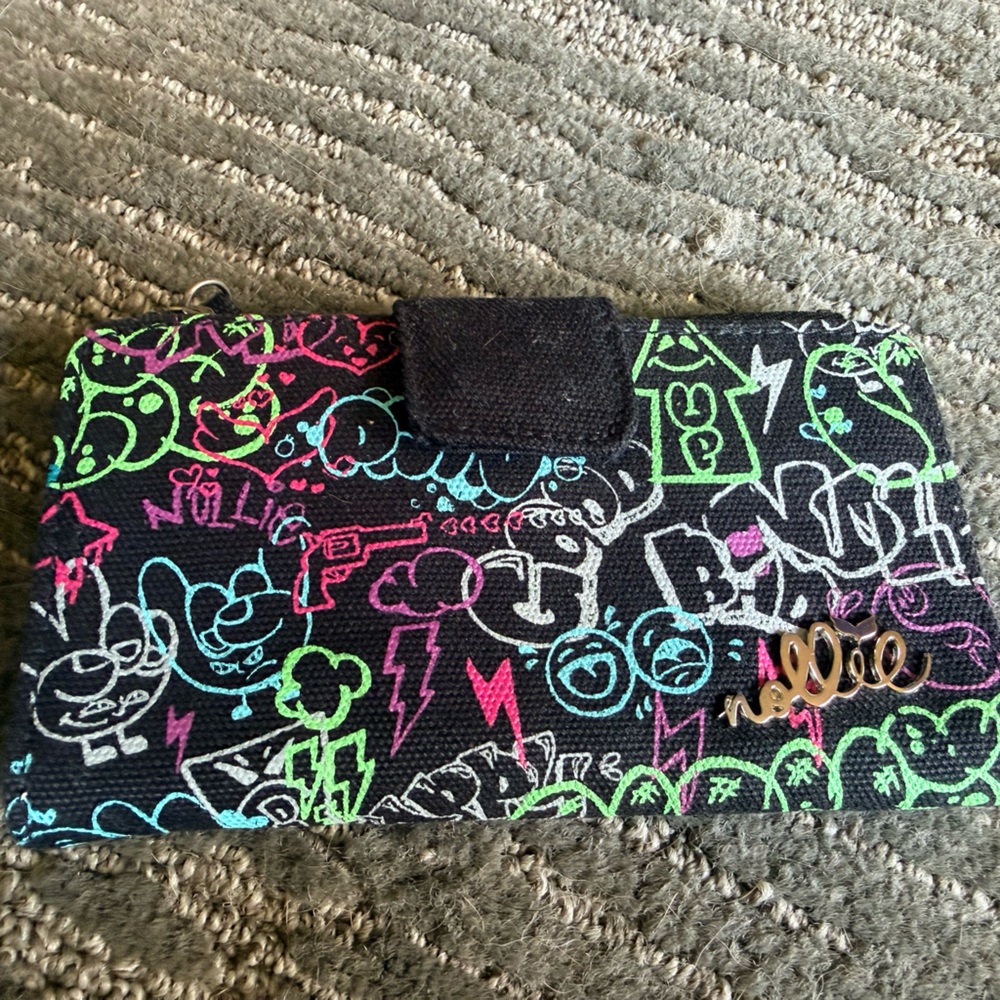 Nollie canvas wallet featuring a black exterior with a vibrant graffiti part